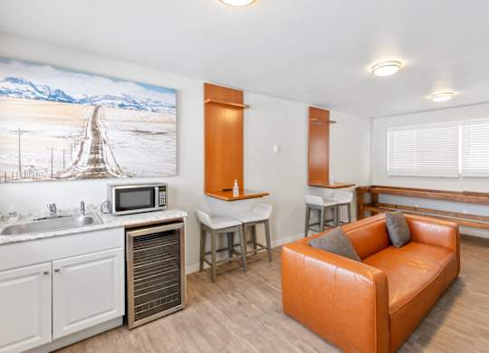 Resident Lounge with a couch and a kitchen with a sink and a counter top at Rock Creek, Billings Montana
