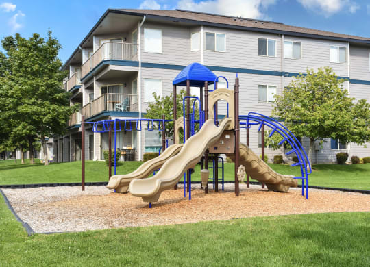 Blue and tan playground at Shoreline Village Apartments in Richland, WA.