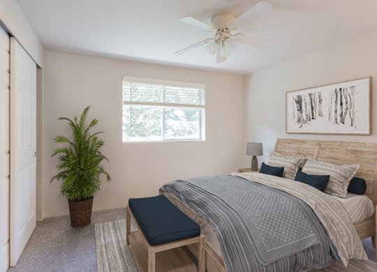 a bedroom with a bed and a ceiling fan
