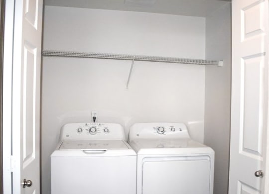 a white washer and dryer sitting next to each other at Sitka Heights, Fife Washington