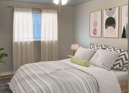 Bedroom with large window, blinds, and ceiling fan. Staged with a queen-size bed, side tables, a house plant, and wall art.at Sitka Heights, Fife, 98424