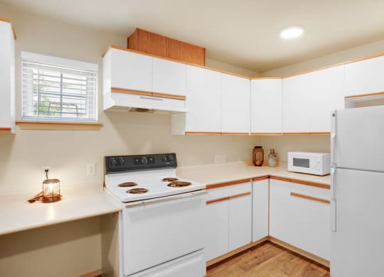 a kitchen with white cabinets and a white stove and white refrigerator at Sky Vue, Bellingham, 98229