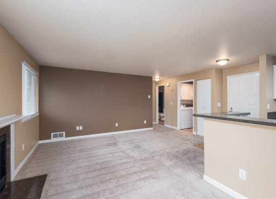 the living room and kitchen of an empty house