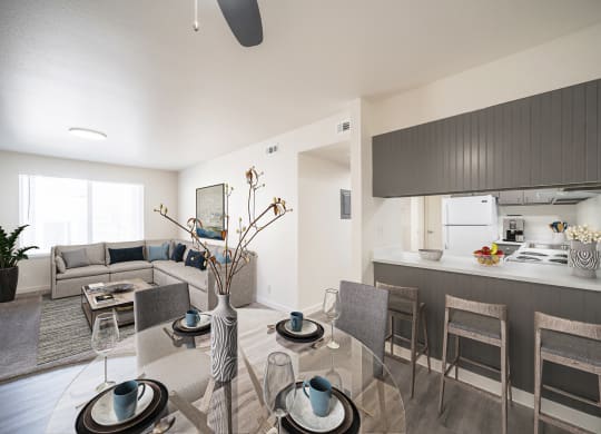 a living room and kitchen with a glass table and chairs at Summit, Pocatello, ID