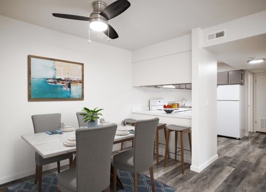 a dining room and kitchen with a table and chairs