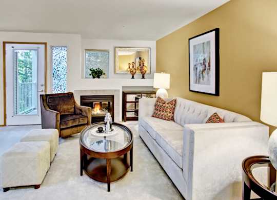 A living room with a white couch and a coffee table.