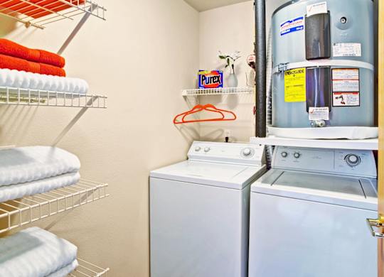 A small laundry room with a washer and dryer.