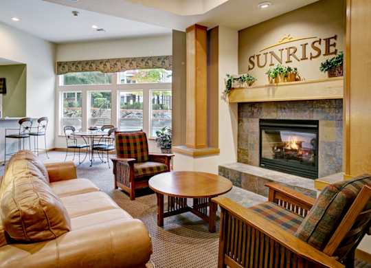A living room with a fireplace and a sign that says Sunrise.