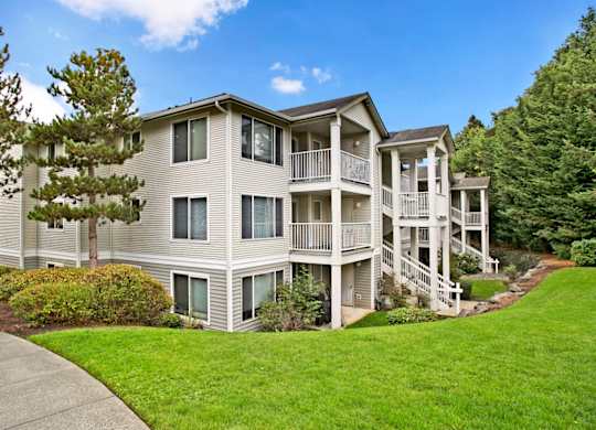 A large, two-story apartment building with a balcony at Sunrise Lane Apartments in Everett