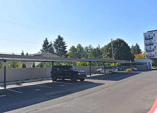 A black car is parked in a parking lot.