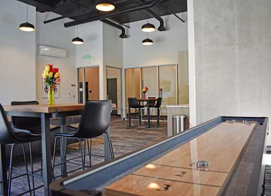 Resident lounge with shuffleboard at The Duo Apartments in University Place, WA.