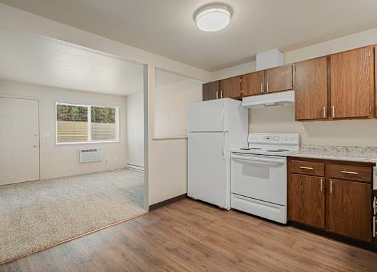 Open concept kitchen and living room in a 1 bedroom apartment at The Lakes Apartments in Moses Lake Washington