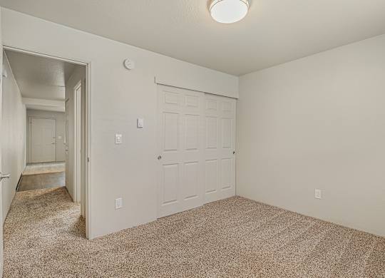 Cozy 1 bedroom apartment bedroom with soft carpet flooring and spacious layout at The Lakes Apartments in Moses Lake WA