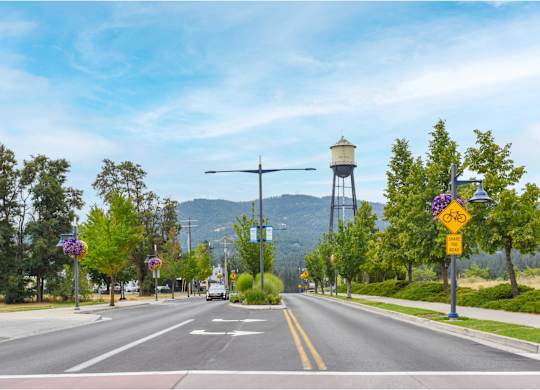 A street view with a crosswalk and a bike lane sign.