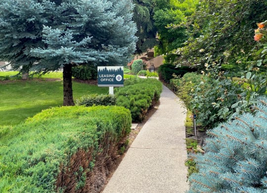 a sidewalk with a sign in that reads leasing office at Castlerock, Wenatchee Washington