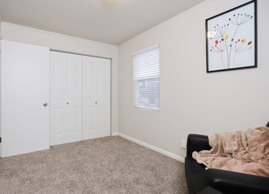 a bright living space with a chair and a door to a closet at Woodhaven, Everett, 98203 