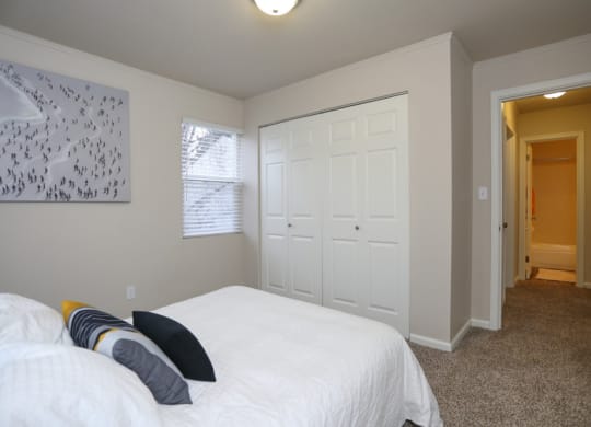 Bedroom with full side bed and 2 panel closet doors.at Woodhaven, Washington