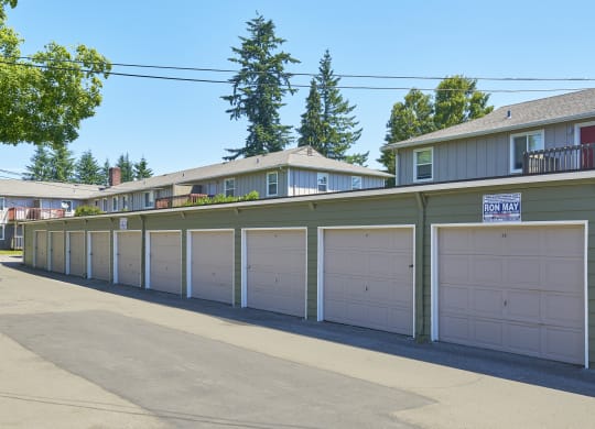 a row of garages with white garage doors in front of houses  at Woodhaven, Everett, WA