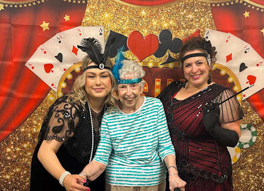 Three people wearing costumes at Campus Commons Senior Living, California