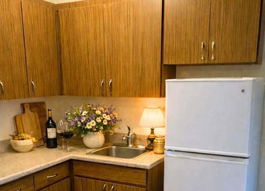 Kitchen with wooden cabinets at River Commons Senior Living, Redding, CA, 96002