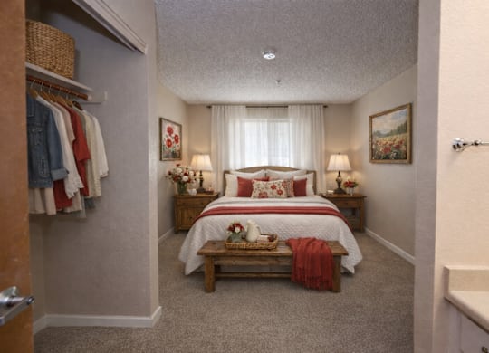Bedroom with walk-in closet and ensuite bathroom at Roseville Commons Senior Living Apartments, Roseville
