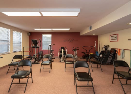 a fitness room with chairs and exercise equipment at Hilltop Commons Senior Living, Grass Valley, CA 95945