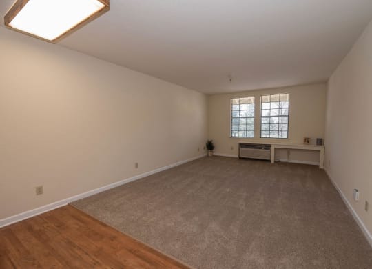 a spacious living room with hardwood floors and a window at Hilltop Commons Senior Living, Grass Valley, 95945