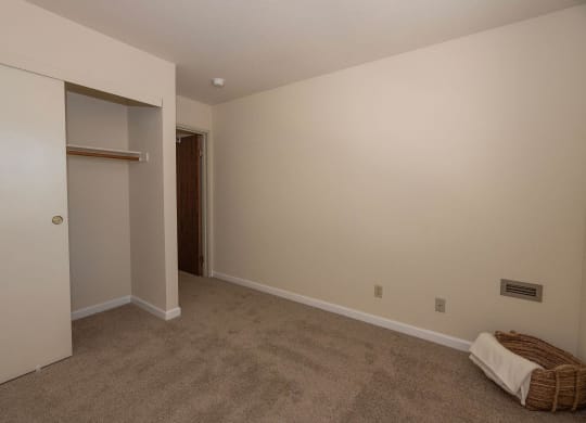 a room with a carpeted floor and a closet at Hilltop Commons Senior Living, Grass Valley California