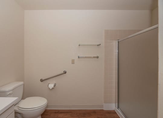 a bathroom with a toilet and a shower and a sink at Hilltop Commons Senior Living, Grass Valley, 95945