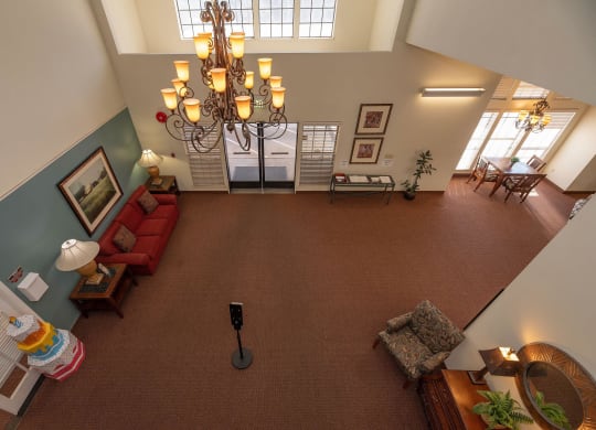 an overhead view of a living room with a chandelier at Hilltop Commons Senior Living, Grass Valley, CA 95945