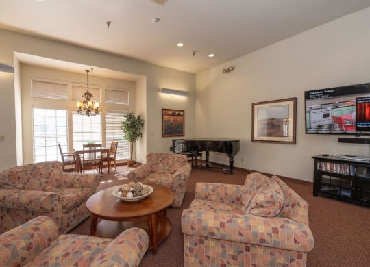 a living room with couches and a table and a television at Hilltop Commons Senior Living, Grass Valley California