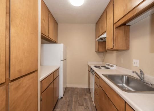 Full kitchen with refrigerator, cabinets and counter space at Lodi Commons Senior Living, California, 95240