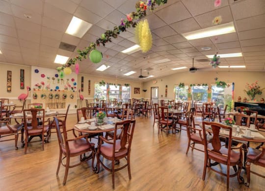 a large dining room with tables and chairs at Lodi Commons Senior Living, California
