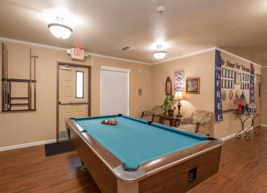 Game room with pool table at Lodi Commons Senior Living, California
