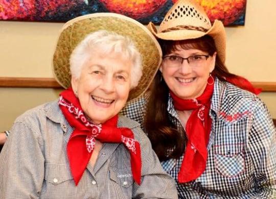 two women wearing hats and scarves are posing for a picture at River Commons Senior Living, Redding, 96002