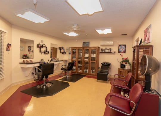 a salon room with a lot of chairs and a fan at Roseville Commons Senior Living, Roseville
