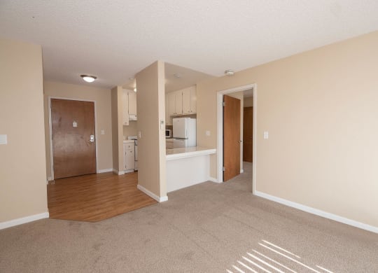 an empty living room and kitchen with an open floor plan at Roseville Commons Senior Living, Roseville