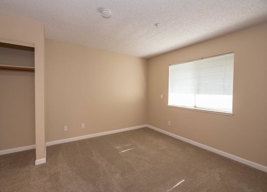 an empty room with a window and a closet at Roseville Commons Senior Living, Roseville, CA 