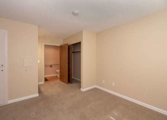 an empty living room with a door to a bathroom at Roseville Commons Senior Living, Roseville, CA 95678