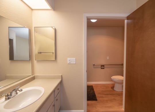 a bathroom with a sink and a toilet at Roseville Commons Senior Living, California