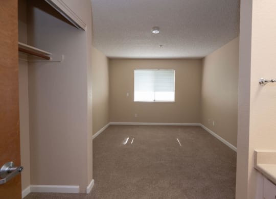 an empty room with a window and a closet at Roseville Commons Senior Living, Roseville, 95678