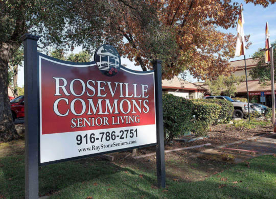 a sign commons senior living in front of a tree at Roseville Commons Senior Living, California