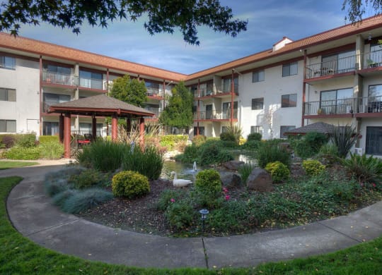 a garden in the middle of an apartment building at Roseville Commons Senior Living, Roseville, 95678