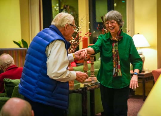two women standing in a room talking to each other at Winding Commons Senior Living, Carmichael, CA, 95608