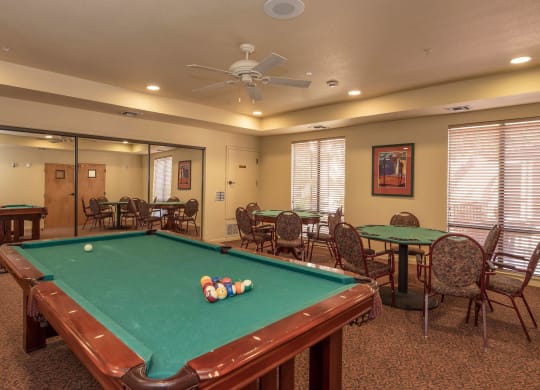 a game room with a pool table and tables at Winding Commons Senior Living, Carmichael, California