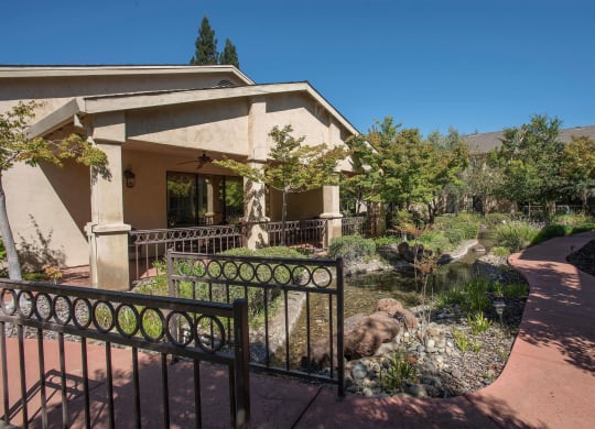 a house with a fence and a garden in front of it at Winding Commons Senior Living, Carmichael, CA