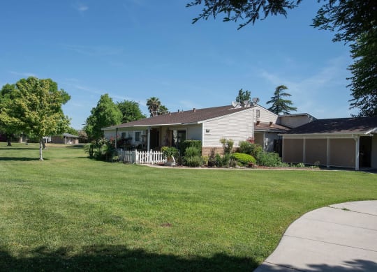 a white house with a yard in front of it at Castle Vista Senior Duplex Community, Atwater, 95301
