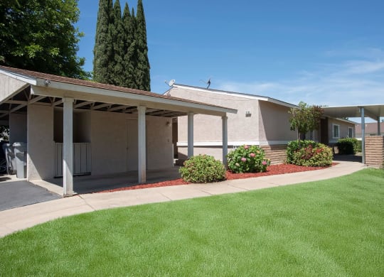 a white building with a lawn in front of it at Castle Vista Senior Duplex Community, Atwater, California