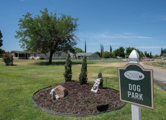 a dog park with a sign in the grass at Castle Vista Senior Duplex Community, Atwater, CA, 95301