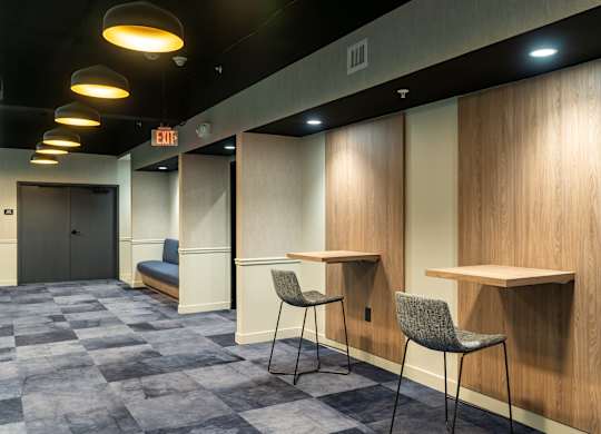 a room with two tables and two chairs and a door at Textile Apartments, Cincinnati, 45202